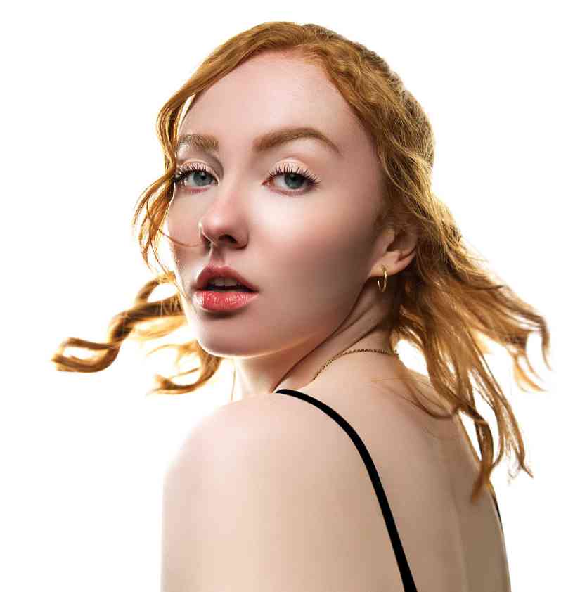 Portrait d'une femme rousse, mèche de cheveux traversant le visage